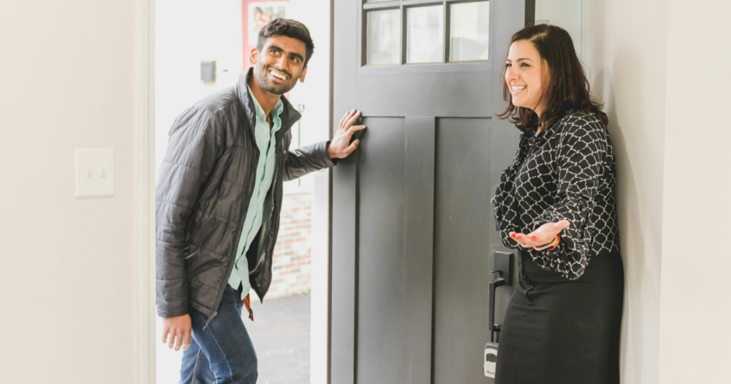 Everythings Landlords need to know about tenant screening mobile - Image of happy tenants at front door to home