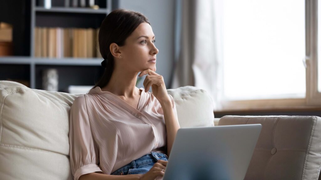 Woman thinking about choosing between rent reporting agencies - Blog cover photo