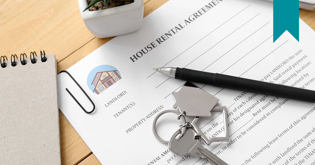 Rental lease agreement with pen and keys to home on lease.