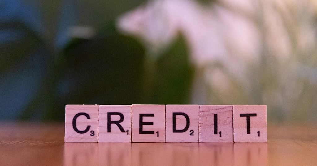 How long can unpaid rent stay on your credit report represented by wooden blocks spelling credit.