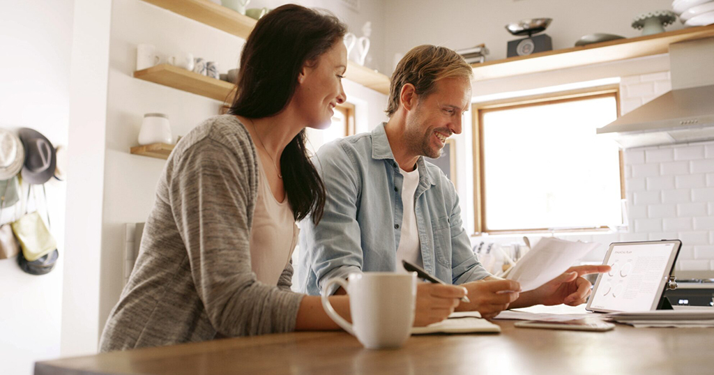 Happy Canadian Tenants reviewing improved credit score from Rent Reporting