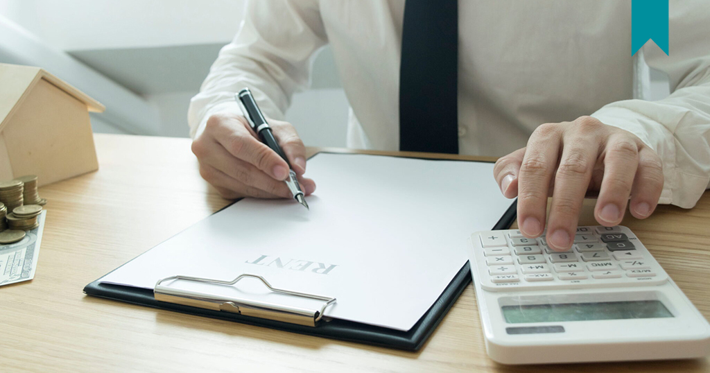 Landlord documenting unpaid rent on paper.