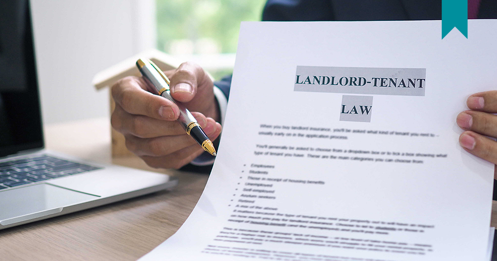 Landlord Tenant Law - Legal document being held and displayed to Landlord and Tenant during dispute.