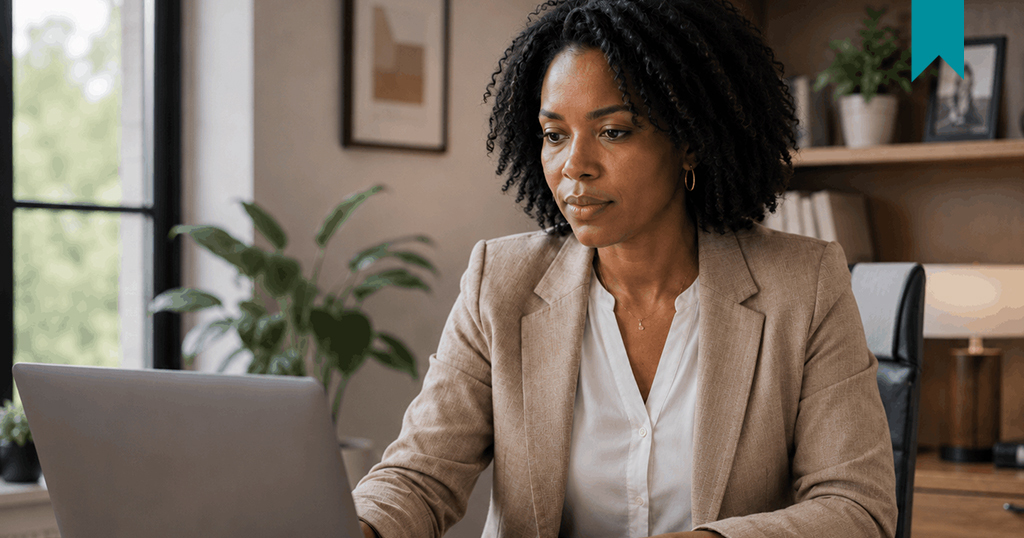 Female Landlord in office reading something on laptop.